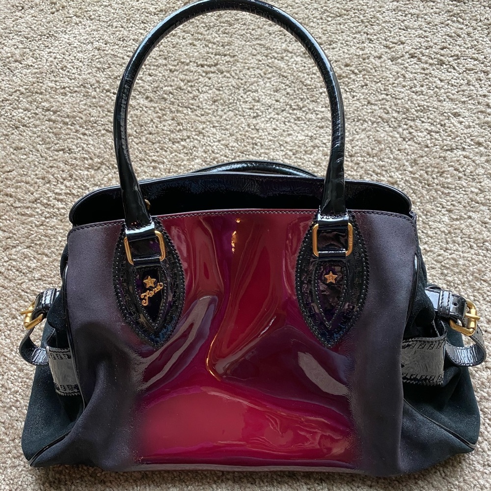 Black, maroon, and gold Fendi hand bag.